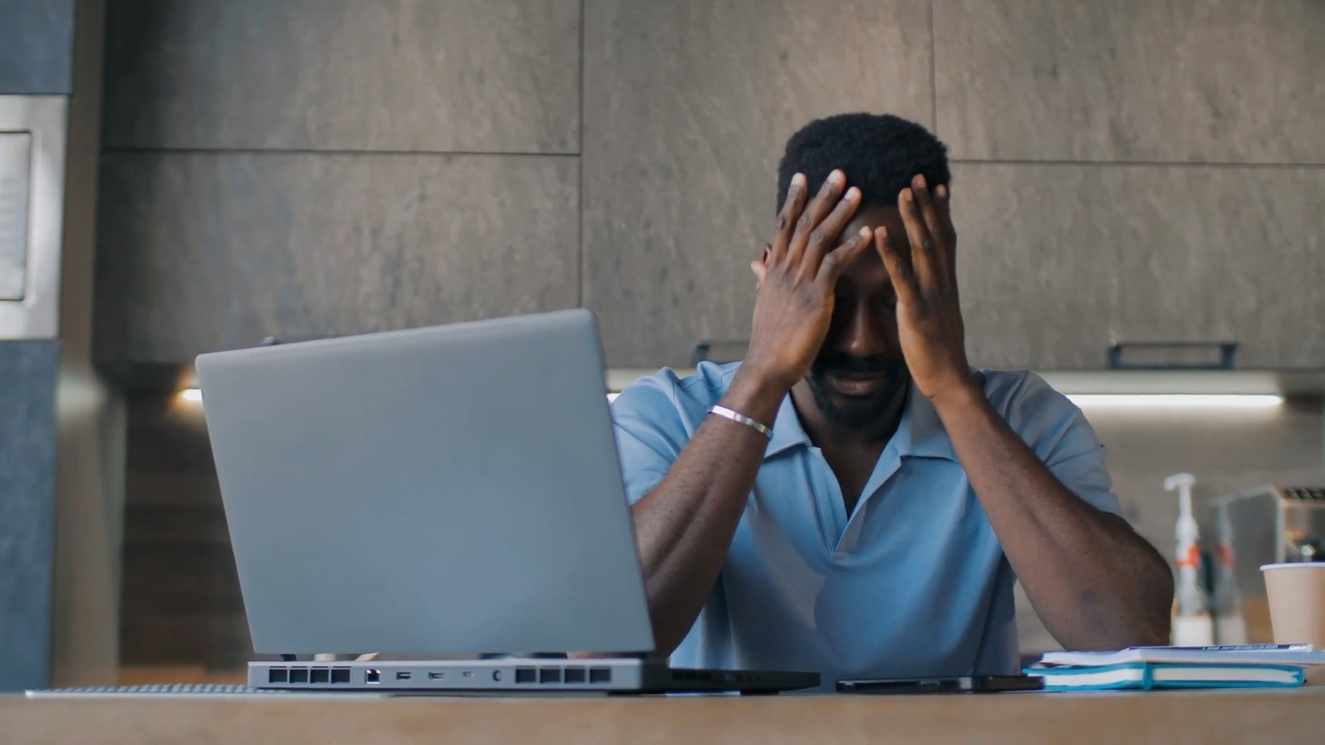 A person working on a computer getting frustrated